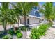 View of the side of the home, beautiful landscaping and white fence at 201 Bay N Dr, Bradenton Beach, FL 34217
