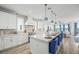 Open-concept kitchen featuring an island with seating, white cabinets, and modern appliances at 201 Bay N Dr, Bradenton Beach, FL 34217