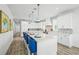 Bright kitchen with a large island, stylish blue seating, and modern stainless steel appliances at 201 Bay N Dr, Bradenton Beach, FL 34217