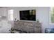 A living room features a large TV, coastal decor, and shiplap walls at 201 Bay N Dr, Bradenton Beach, FL 34217