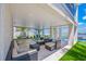 Relaxing covered outdoor patio with stylish furniture and a view of the pool and waterfront at 201 Bay N Dr, Bradenton Beach, FL 34217