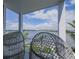 A covered porch features comfortable seating and views of the waterfront at 201 Bay N Dr, Bradenton Beach, FL 34217