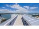 Spacious rooftop deck with beautiful water views, modern railings, and a light-colored wooden floor at 201 Bay N Dr, Bradenton Beach, FL 34217