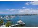 A waterfront view showcases docks, boats, and a bridge under a blue sky with fluffy clouds at 201 Bay N Dr, Bradenton Beach, FL 34217