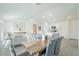 Open-concept space with a wooden dining table and upholstered chairs, flowing into the living room at 20276 Emerald Ave, Port Charlotte, FL 33952