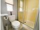 Clean bathroom featuring a shower stall, toilet, and neutral-toned tile, offering a refreshing space at 2107 Palma Sola Blvd # 95, Bradenton, FL 34209