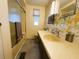 Bathroom featuring a vanity with a sink, mirror, tub with shower, and eclectic wallpaper, offering a functional and charming space at 2107 Palma Sola Blvd # 95, Bradenton, FL 34209