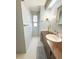 Cozy bathroom featuring a vanity with a mirror, storage and a walk-in closet area, offering a functional space at 2107 Palma Sola Blvd # 95, Bradenton, FL 34209