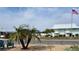 Charming exterior with palm trees and a well-maintained landscape near the beach at 2107 Palma Sola Blvd # 95, Bradenton, FL 34209