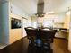 Bright kitchen featuring an island with seating, modern appliances, and white cabinets, offering a charming space to cook at 2107 Palma Sola Blvd # 95, Bradenton, FL 34209