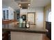 Charming kitchen island with bar seating, featuring white cabinetry and stainless steel hood, providing a casual gathering spot at 2107 Palma Sola Blvd # 95, Bradenton, FL 34209