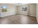 Empty, bright bedroom featuring updated floors and views of the outside landscaping at 214 49Th W St, Bradenton, FL 34209