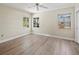 Bright bedroom with hardwood floors and natural light from multiple windows overlooking outside landscaping at 214 49Th W St, Bradenton, FL 34209
