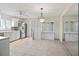 Spacious kitchen with tile floors, stainless steel refrigerator, and white cabinets and appliances at 214 49Th W St, Bradenton, FL 34209