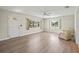 Bright living room featuring updated floors, a ceiling fan, and abundant natural light, creating a welcoming atmosphere at 214 49Th W St, Bradenton, FL 34209