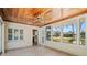 Bright sunroom with a wood ceiling, tile floor and windows that offer natural light and outdoor views at 214 49Th W St, Bradenton, FL 34209