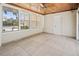 Enclosed sunroom featuring a wood ceiling, tiled floor, and lots of natural light at 214 49Th W St, Bradenton, FL 34209