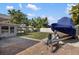 Backyard featuring a boat on a trailer, stone patio, and outdoor entertaining and dining space at 2202 Alpine Ave, Sarasota, FL 34239