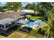 Aerial view of backyard featuring pool, patio with lounge chairs, and meticulous landscaping at 2202 Alpine Ave, Sarasota, FL 34239