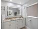 Bright bathroom with double vanity, granite countertops, and an illuminated mirror at 2202 Alpine Ave, Sarasota, FL 34239