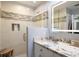 Modern bathroom with a tiled shower, granite countertop, and vanity with storage at 2202 Alpine Ave, Sarasota, FL 34239