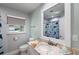 Bright bathroom featuring granite countertop, a white framed mirror and blue shark themed shower curtain at 2202 Alpine Ave, Sarasota, FL 34239