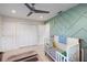 Charming Bedroom with a crib, ample closet space, and a colorful accent wall at 2202 Alpine Ave, Sarasota, FL 34239