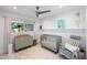 Comfortable Bedroom with a green crib, rocking chair, and changing table with a patterned rug at 2202 Alpine Ave, Sarasota, FL 34239