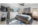 Cozy bedroom with minimalist decor, natural light, and a ceiling fan at 2202 Alpine Ave, Sarasota, FL 34239