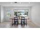 Minimalist dining room with a large window offering natural light, tile floors, and seating for four at 2202 Alpine Ave, Sarasota, FL 34239