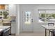 Bright entryway featuring a decorative glass door, modern tile flooring, and a view into the dining area at 2202 Alpine Ave, Sarasota, FL 34239