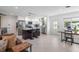 Kitchen featuring a central island with seating, stainless steel appliances, and connection to the living area at 2202 Alpine Ave, Sarasota, FL 34239