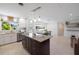 Kitchen island featuring pendant lighting, granite countertops and a seamless transition to the dining and living area at 2202 Alpine Ave, Sarasota, FL 34239