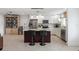 Kitchen island featuring granite countertops, seating, and modern stainless steel appliances in the background at 2202 Alpine Ave, Sarasota, FL 34239