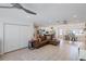 Spacious living area with tile flooring, ceiling fan, and view of dining area and kitchen at 2202 Alpine Ave, Sarasota, FL 34239