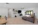 Spacious living room with neutral tile flooring, modern floating shelves, and sliding doors to the pool at 2202 Alpine Ave, Sarasota, FL 34239