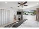 Bright main bedroom with a TV, ensuite bathroom, and natural light at 2202 Alpine Ave, Sarasota, FL 34239