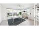 Bright office with natural light, modern desk, decorative shelving, and backyard view at 2202 Alpine Ave, Sarasota, FL 34239