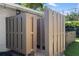 Enclosed outdoor shower with wood-style paneling offers privacy and convenience at 2202 Alpine Ave, Sarasota, FL 34239