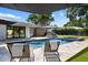 Inviting pool with lounge chairs, spa, fountains, and an outdoor kitchen area provides the perfect spot for relaxation at 2202 Alpine Ave, Sarasota, FL 34239