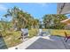 Green backyard boasts a grill, seating area and mature landscaping at 2307 Valencia Dr, Sarasota, FL 34239
