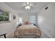 Comfortable bedroom featuring a ceiling fan and sunny windows at 2307 Valencia Dr, Sarasota, FL 34239