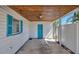 Covered carport space with blue painted door and shutter window at 2307 Valencia Dr, Sarasota, FL 34239