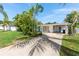 Charming single story home featuring a long driveway and tropical landscaping at 2307 Valencia Dr, Sarasota, FL 34239