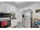 Modern kitchen with stainless steel appliances, white cabinetry, and striking floor tiles at 2307 Valencia Dr, Sarasota, FL 34239