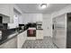 Well-maintained kitchen featuring stainless steel refrigerator and black and white patterned floors at 2307 Valencia Dr, Sarasota, FL 34239