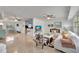 Bright and open living room with ceiling fan, polished floors, and access to the kitchen at 2307 Valencia Dr, Sarasota, FL 34239