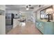 Open concept living area with terrazzo floors and updated light fixtures at 2307 Valencia Dr, Sarasota, FL 34239