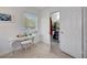 Well-lit room with a window, desk, chair and an open door to the bathroom at 2307 Valencia Dr, Sarasota, FL 34239