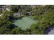Aerial view of tennis courts surrounded by lush greenery at 308 Timber Lake Dr, Bradenton, FL 34210